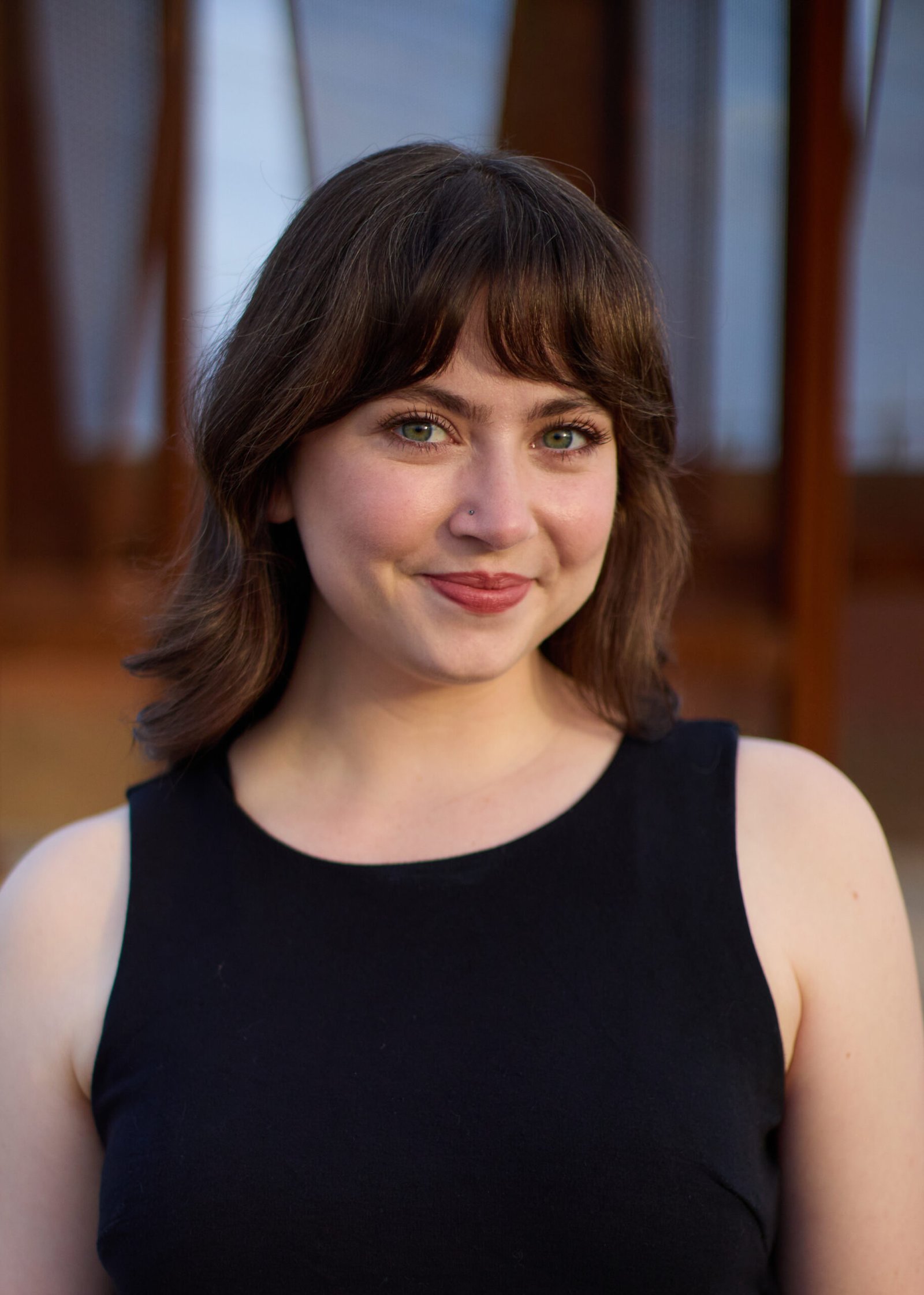 Headshot of Brenna, founder of Ictus Solutions, smiling in an outdoor setting.